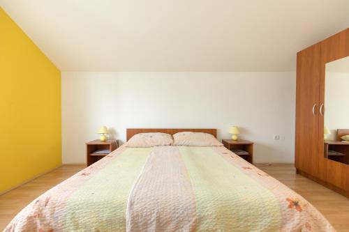 a bedroom with a large bed with two night stands at Guesthouse Capistro in Bilje