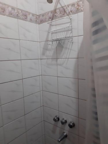 a bathroom with a shower with white tiles at KARMEL "tu lugar' in Maipú