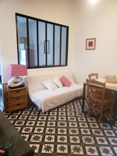 a living room with a couch and a table at le balcon in Camps-sur-lʼAgly