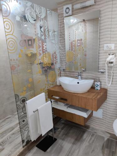 a bathroom with a sink and a mirror at Euphoria Olimp in Olimp