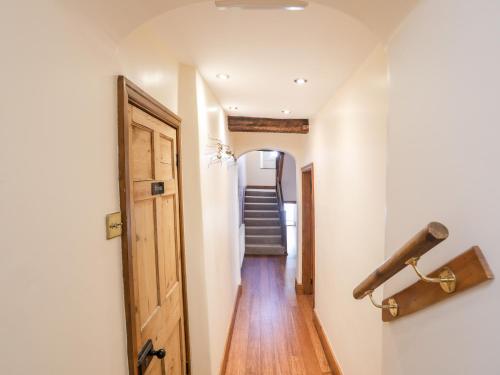 a hallway with a wooden door and a stairway at Above Deck in Beaumaris