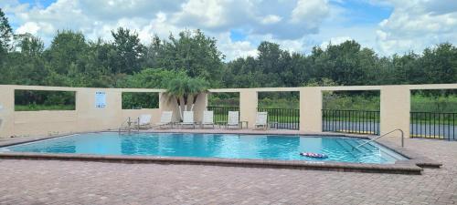 a swimming pool with a person laying in the water at Shining Light Inn & Suites in Kissimmee