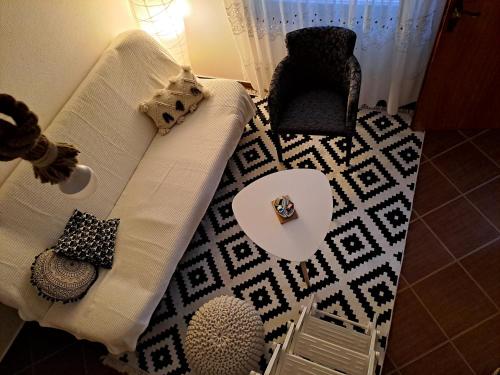 a living room with a white couch and a table at Love Shack in Kolašin