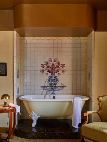 a bath tub in a bathroom with a tile wall at Hotel Ulysses, a Member of Design Hotels in Baltimore