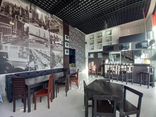 a dining room with tables and chairs and a mural at Pontevedra Hotel Boutique in Paipa