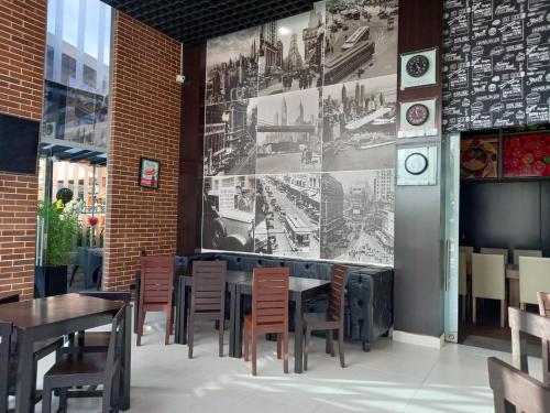a restaurant with tables and chairs and a clock on the wall at Pontevedra Hotel Boutique in Paipa