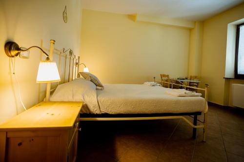 a hospital room with a bed and a lamp at L'Incanto dei Sibillini in Cessapalombo