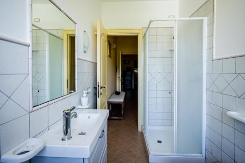 a white bathroom with a sink and a shower at L'Incanto dei Sibillini in Cessapalombo
