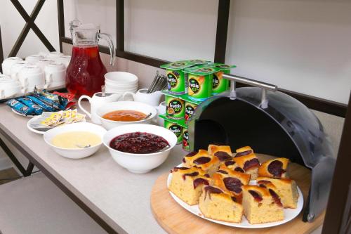 a counter with a table with a loaf of bread and other ingredients at Bonjour Boutique Hotel Yerevan in Yerevan