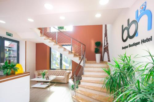 a lobby of a hospital with stairs and plants at Bonjour Boutique Hotel Yerevan in Yerevan