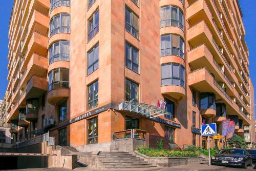 a tall brick building with stairs in front of it at Bonjour Boutique Hotel Yerevan in Yerevan