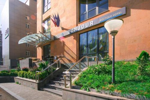 a building with a staircase in front of a building at Bonjour Boutique Hotel Yerevan in Yerevan