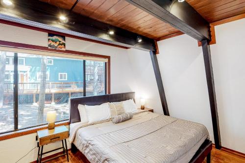 a bedroom with a bed and a large window at Chapel Grove in Tahoe City