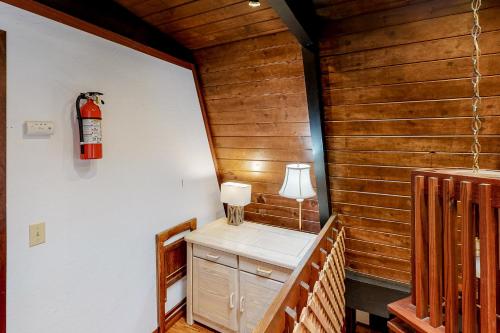 a room with a desk and a fire extinguisher on the wall at Chapel Grove in Tahoe City