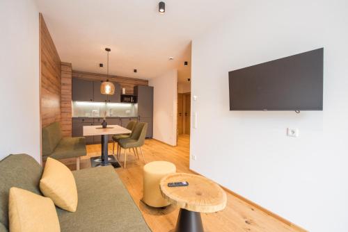a living room with a couch and a table at Hotel-Restaurant Gruber in Pöllau
