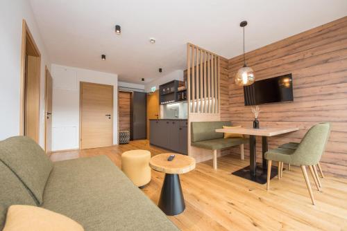 a living room with a couch and a table at Hotel-Restaurant Gruber in Pöllau