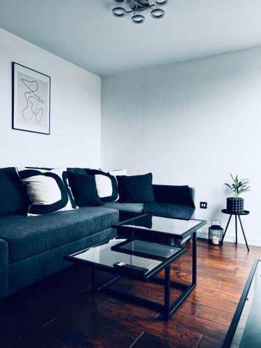 a living room with a couch and a glass table at 2 Bedroom Penthouse Birmingham in Birmingham