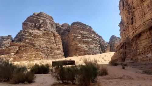 a view of a canyon with rocks and a building at Atef camp in Wadi Rum
