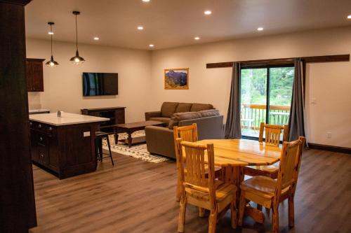 a kitchen and living room with a table and chairs at Glacier Homestead in Coram