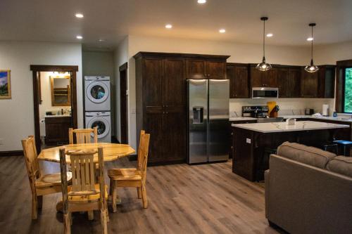 a kitchen and dining room with a table and chairs at Glacier Homestead in Coram