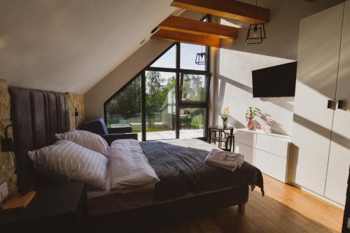 a bedroom with a bed and a large window at Kazimierska Oaza in Kazimierz Dolny