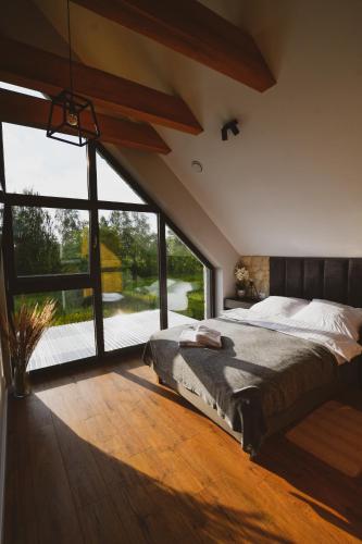 a bedroom with a large bed and a large window at Kazimierska Oaza in Kazimierz Dolny