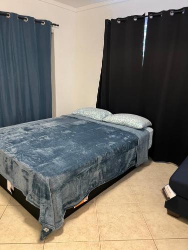 1 dormitorio con 1 cama con cortina negra en Amazing 1bd apartment with big office, en Los Ángeles