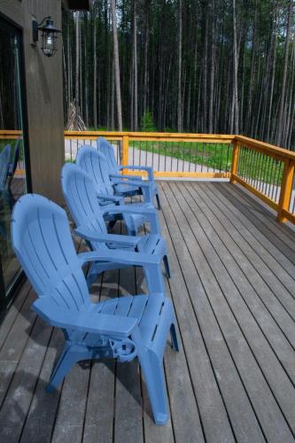 a group of blue chairs sitting on a deck at Glacier Homestead in Coram