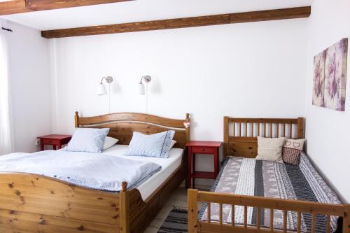 a bedroom with a wooden bed and a bench at u Jaňola in Oščadnica