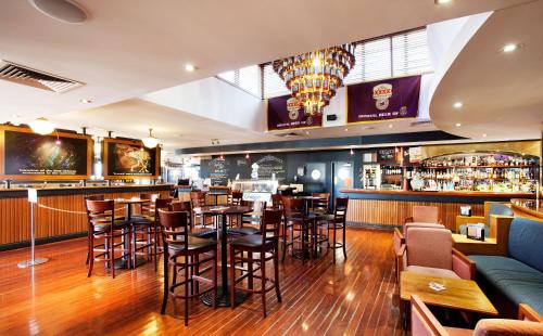 a bar in a restaurant with tables and chairs at Wilsonton Hotel Toowoomba in Toowoomba