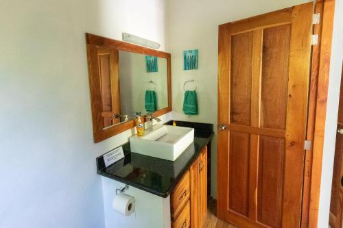 a bathroom with a sink and a mirror at Casa Paraíso - 2nd Floor in San Juan del Sur
