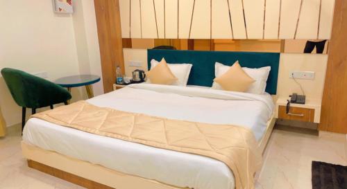 a bedroom with a large bed with a green headboard at City View With Garden -5 Mins Walk From GOLDEN TEMPLE in Amritsar