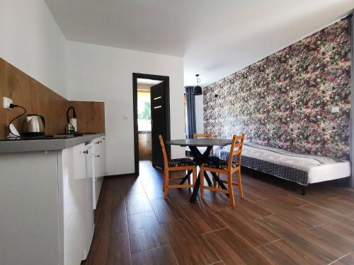 een keuken en een eetkamer met een tafel en stoelen bij Willa CIS in Karpacz