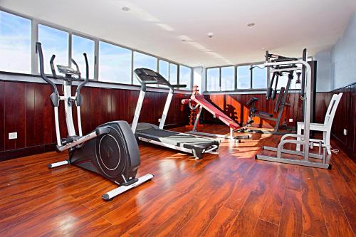 a gym with several exercise equipment in a room at Golden Rain 2 Hotel in Nha Trang