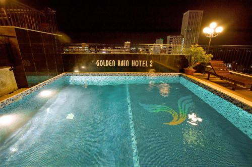 a swimming pool on top of a building at night at Golden Rain 2 Hotel Nha Trang Beach in Nha Trang