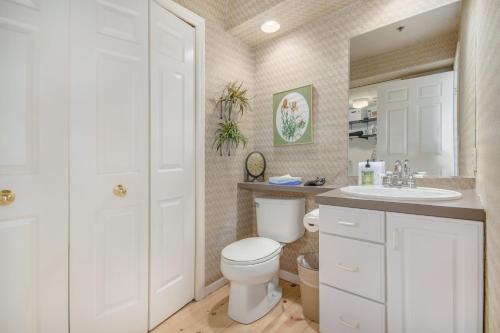 a bathroom with a white toilet and a sink at Hoopdee Scootee Suite in Saugatuck