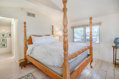 a bedroom with a wooden bed with a wooden frame at Hoopdee Scootee Suite in Saugatuck