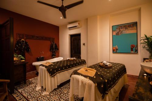 a bathroom with two beds and a sink at Hotel Penaga in George Town
