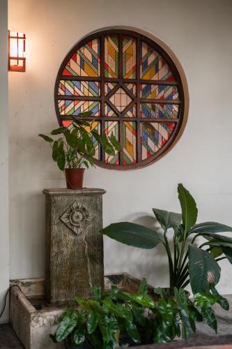 a stained glass window in a room with plants at Hotel Penaga in George Town
