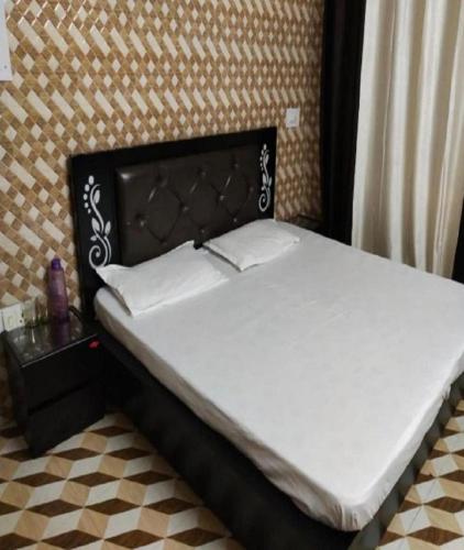 Ένα ή περισσότερα κρεβάτια σε δωμάτιο στο Kumar Home Stay by StayApart