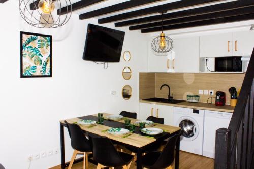 a kitchen and dining room with a table and chairs at F2 Duplex chez l'aventurière près Disneyland in Roissy-en-Brie