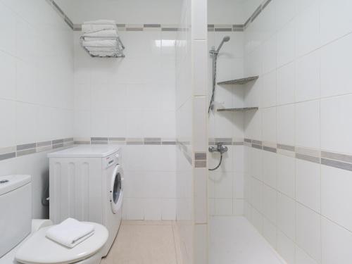 a white bathroom with a toilet and a shower at Marina nº 5 in Puerto de Mogán