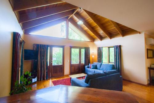 a living room with a couch and a table at Perricoota Vines Retreat in Moama