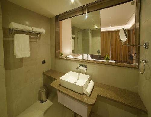 a bathroom with a sink and a mirror at The Pribson Hotel in Amritsar