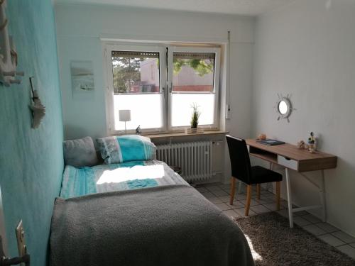 1 dormitorio con cama, escritorio y escritorio en Ferienhaus Elwetritsche in Landau/Pfalz, en Landau in der Pfalz