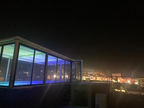 a building with a view of a city at night at Uyut apartments in Majdal Shams