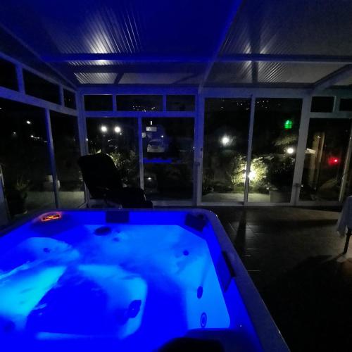 a blue bath tub in a room with a night view at Antica Conca D'oro in Ogliastro Cilento