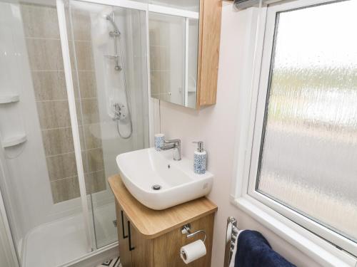 a bathroom with a sink and a shower at Chantry Lodge in Newquay