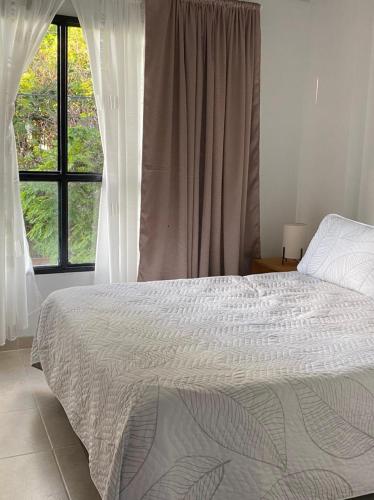 a bedroom with a large bed and a window at Pequeño Paraíso 2 in El Placer