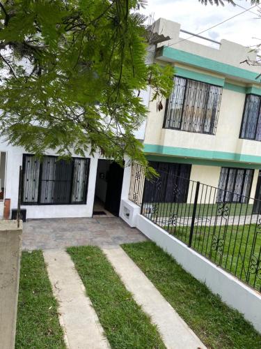 a house with a fence in front of it at Pequeño Paraíso 2 in El Placer